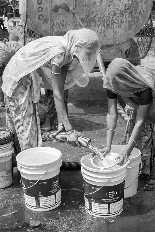 Industry and Violation of Human Right to Water - Unclean tanker water being collected, using a filter to clear the contamination in Bichhadi, Udaipur district, Rajasthan